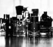 grayscale photo of perfume bottles