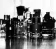 grayscale photo of perfume bottles