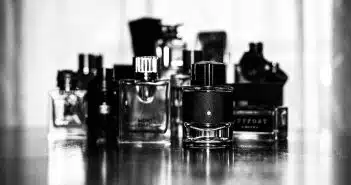 grayscale photo of perfume bottles