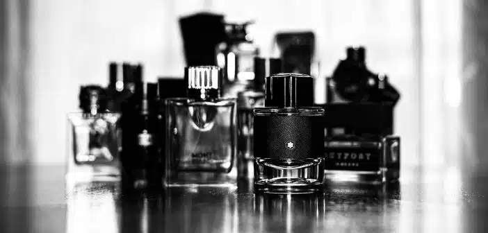 grayscale photo of perfume bottles