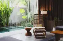 brown wooden chair and stool beside swimming pool