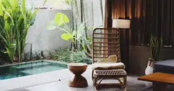 brown wooden chair and stool beside swimming pool