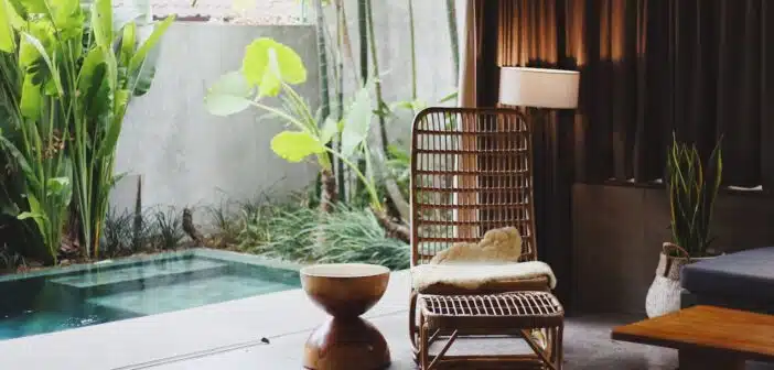 brown wooden chair and stool beside swimming pool